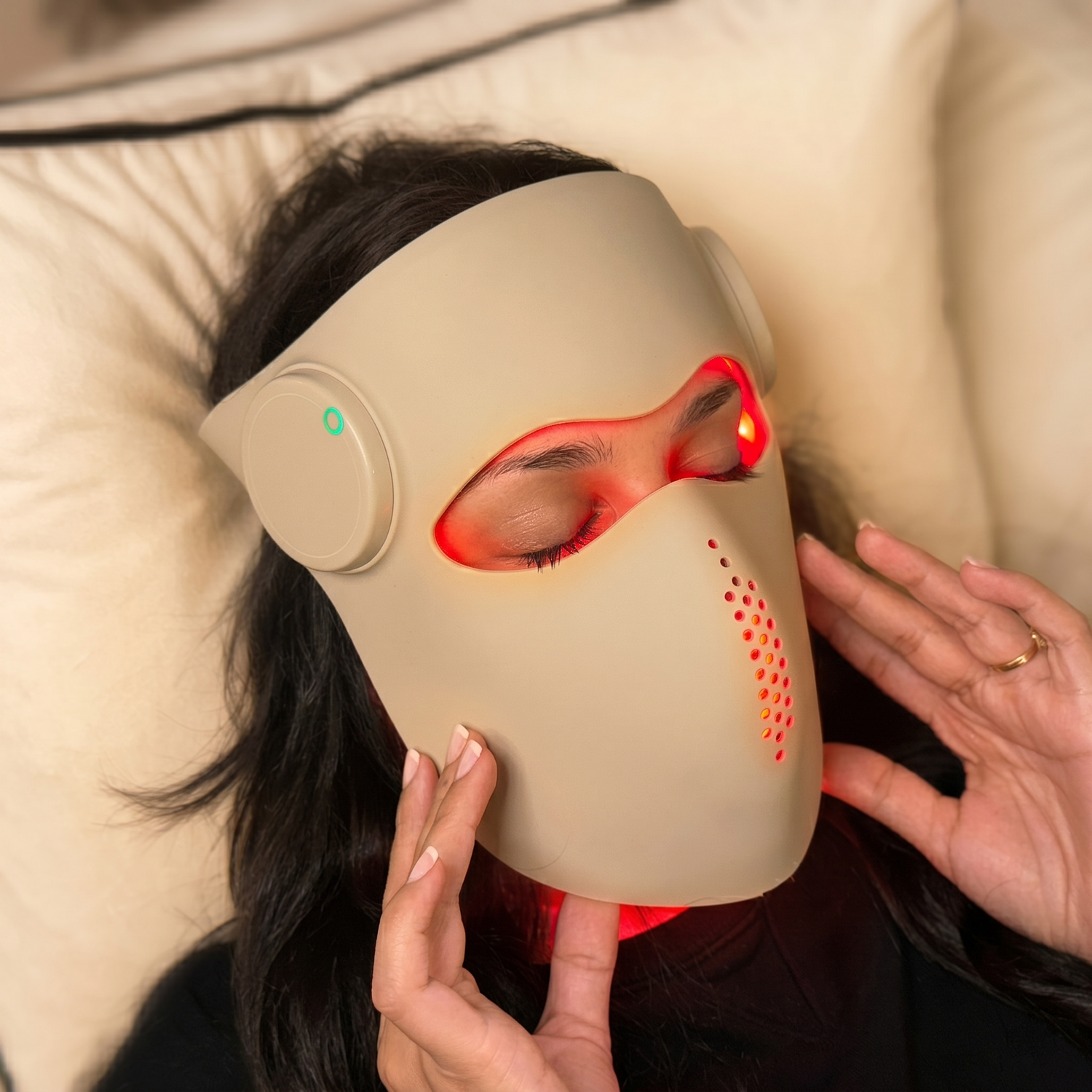 Woman relaxing with Renuveil LED mask showing red light